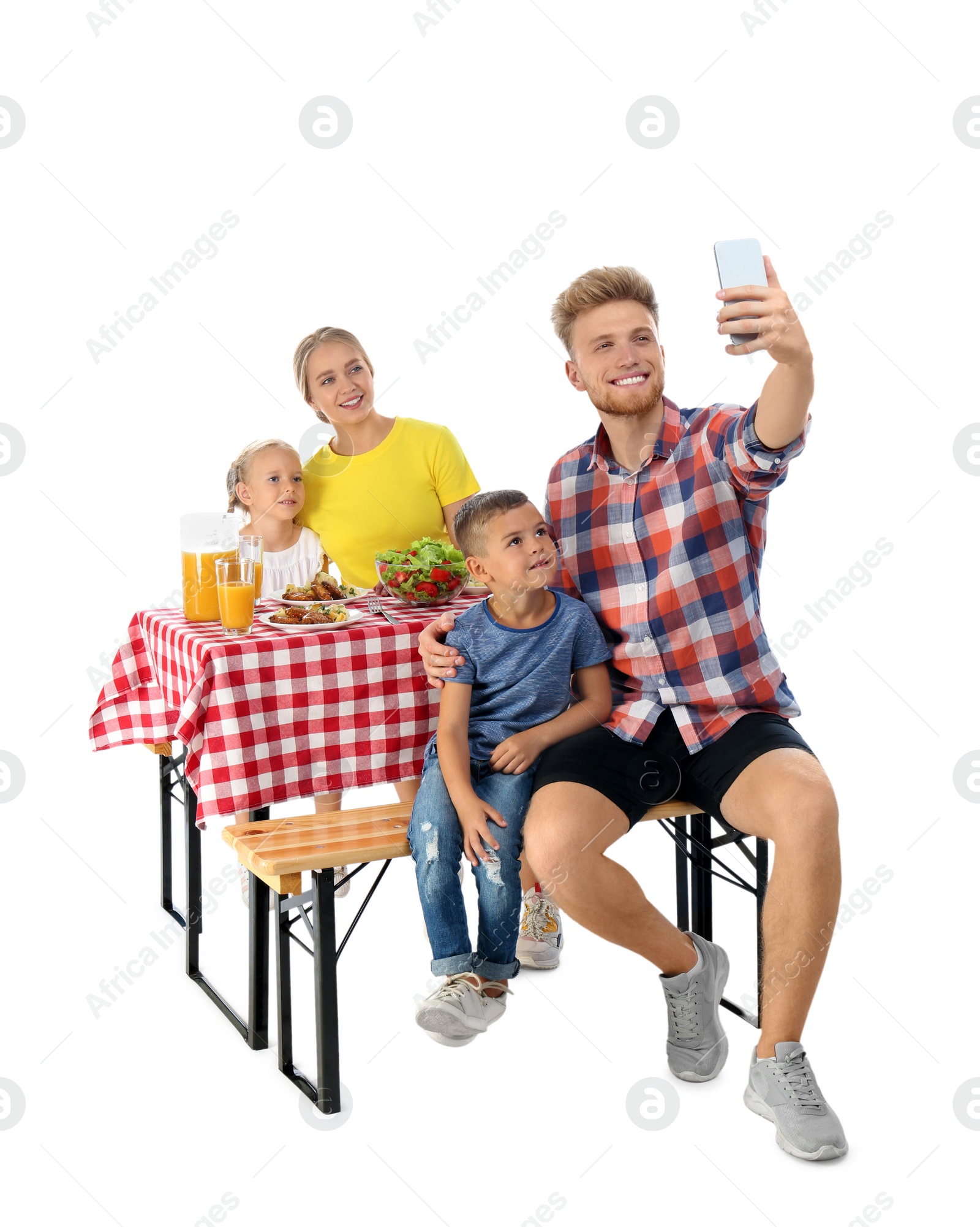 Photo of Happy family taking selfie at picnic table on white background