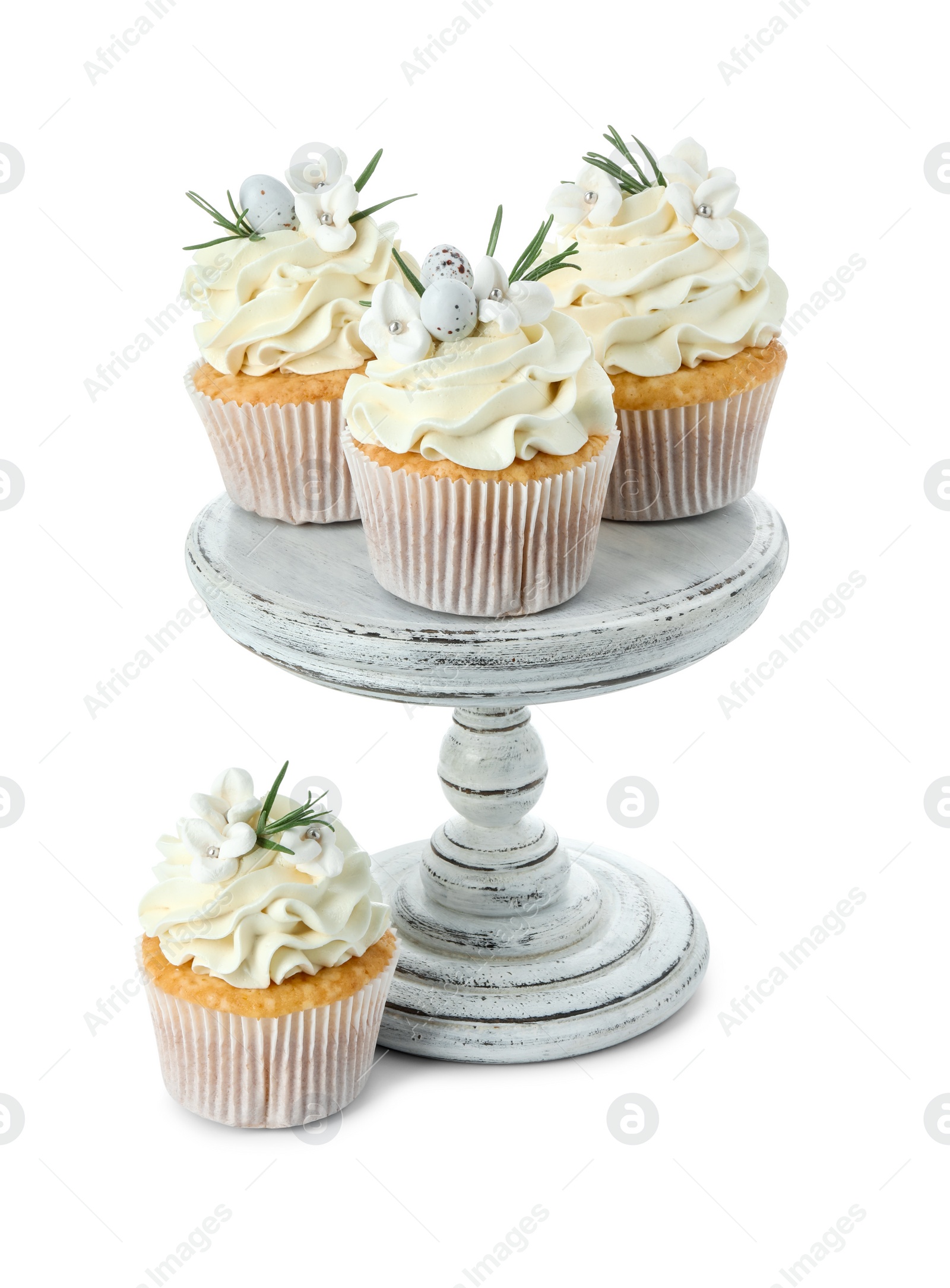 Photo of Tasty Easter cupcakes with vanilla cream isolated on white