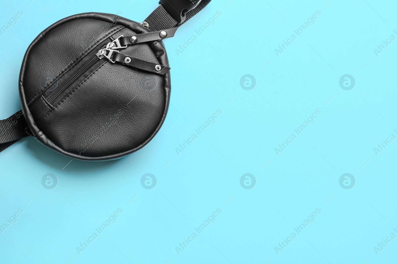 Photo of New stylish bum bag on color background, top view. Space for text