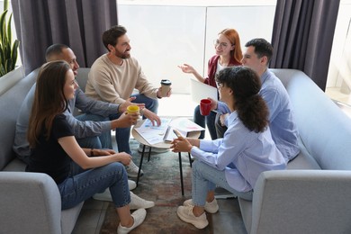 Photo of Team of employees working together in office. Startup project