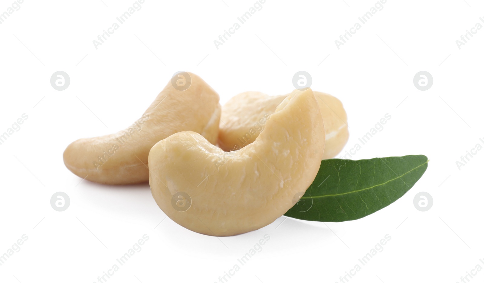 Photo of Tasty organic cashew nuts and green leaf isolated on white, closeup