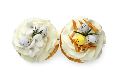 Photo of Tasty Easter cupcakes with vanilla cream isolated on white, top view