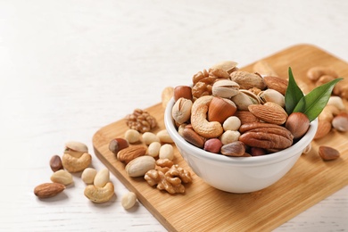 Photo of Bowl with organic mixed nuts on table. Space for text
