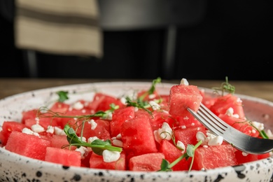 Photo of Delicious salad with watermelon served on plate, closeup