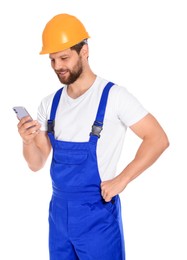 Professional repairman in uniform with smartphone on white background