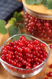 Ripe red currants and leaves on table, closeup