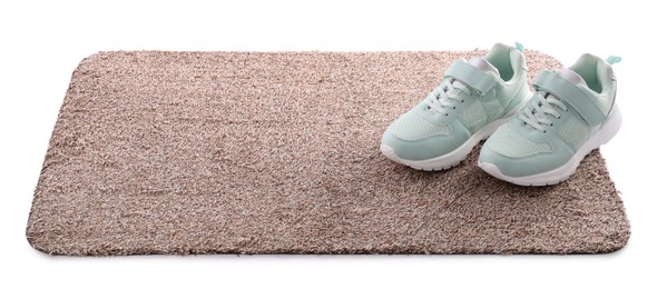 Stylish door mat with shoes on white background