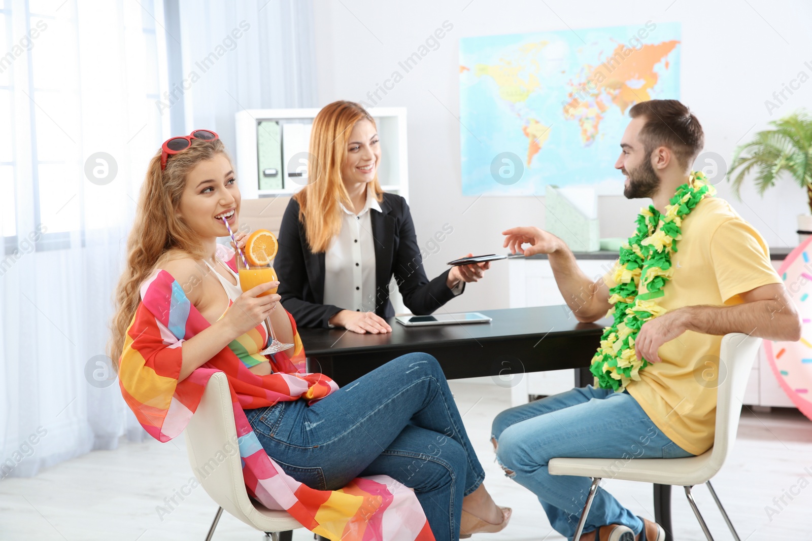 Photo of Beautiful young couple visiting travel agency office