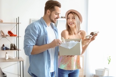 Young couple choosing shoes in store