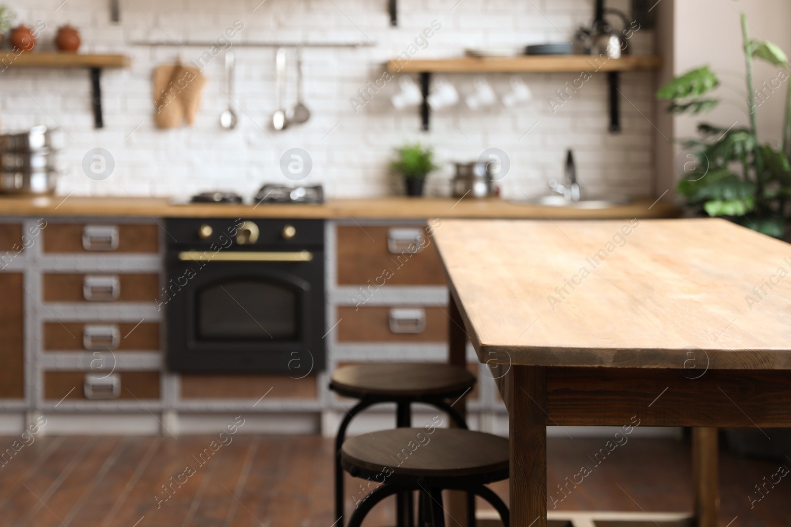 Photo of Empty wooden table in beautiful kitchen. Interior design