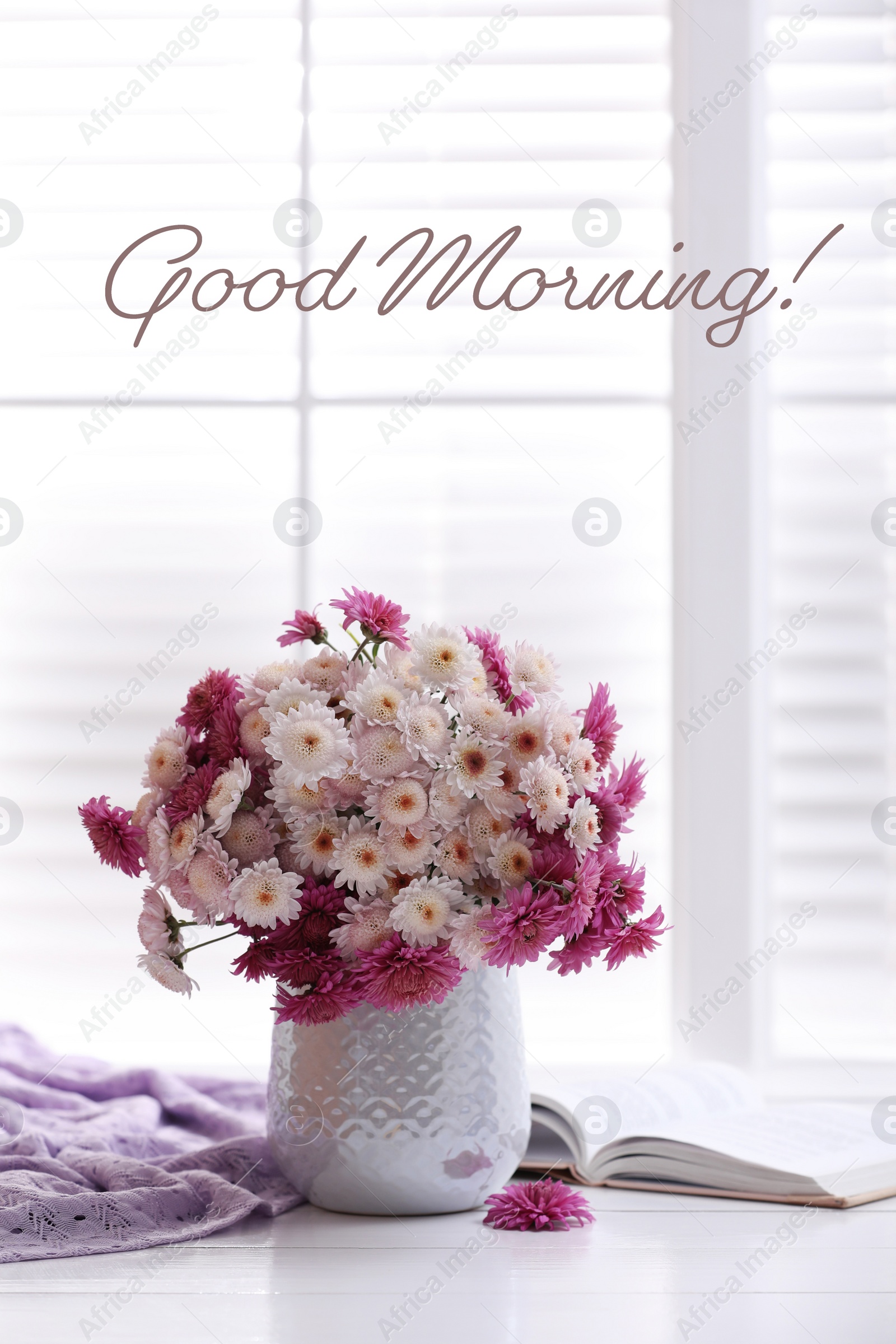 Image of Good morning! Beautiful bouquet and open book on white wooden table near window