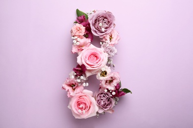 Photo of Number 8 made of beautiful flowers on violet background, flat lay. International Women's day
