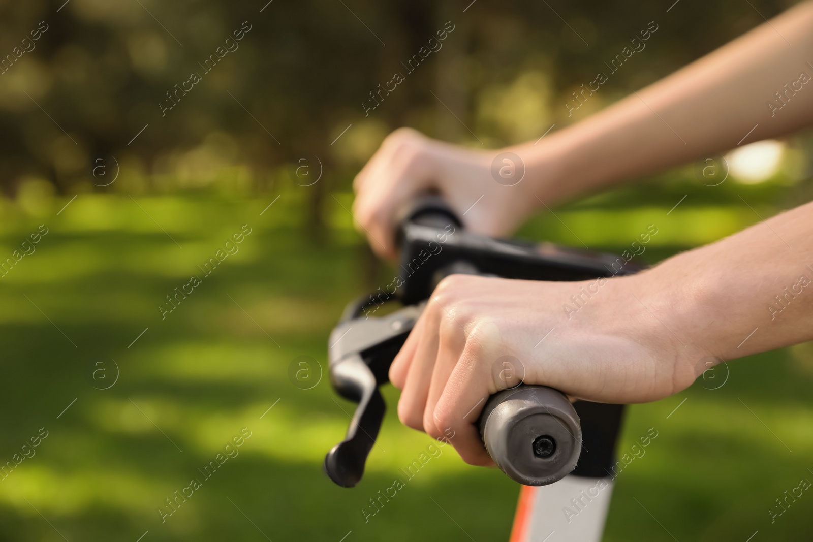 Photo of Man riding modern electric scooter in park, closeup