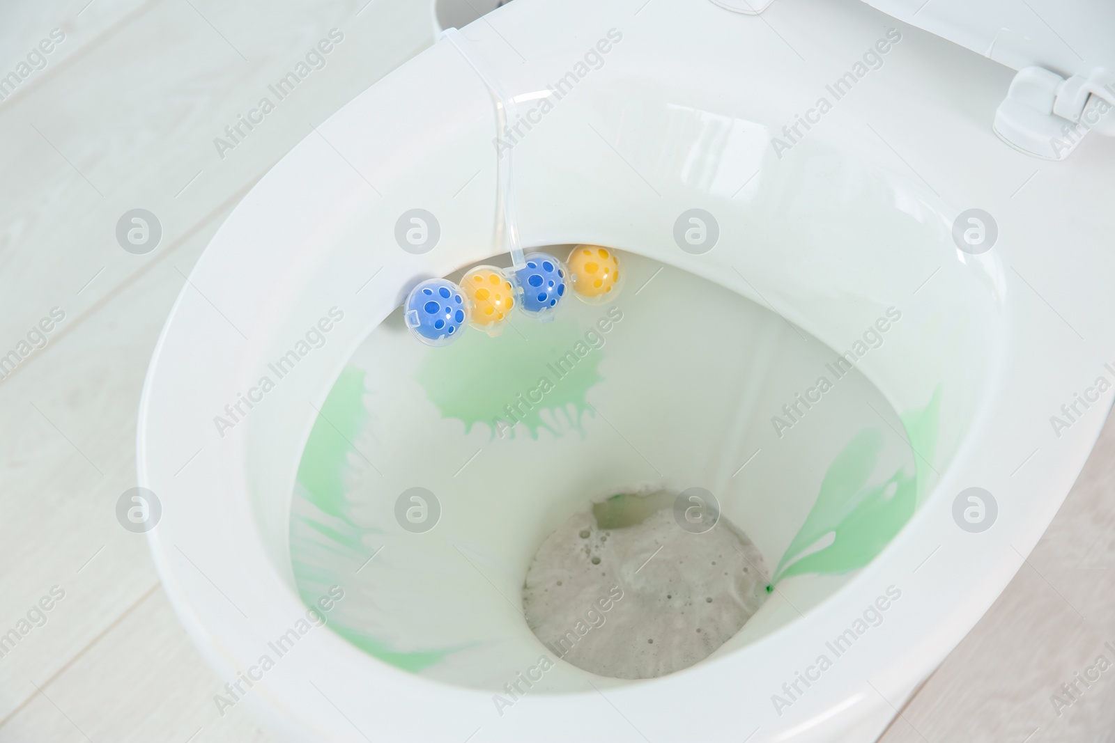 Photo of Ceramic toilet bowl with detergent in modern bathroom