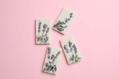 Beautiful scented sachets with flowers on pink background