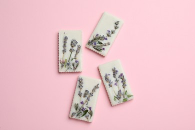 Photo of Beautiful scented sachets with flowers on pink background