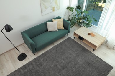Photo of Living room interior with soft grey carpet and modern furniture, above view