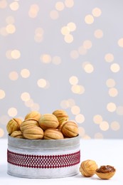 Photo of Homemade walnut shaped cookies with boiled condensed milk on white table. Bokeh effect