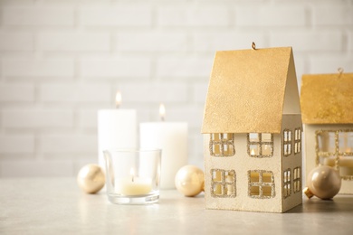 Photo of Composition with house shaped candle holders on light table. Christmas decoration