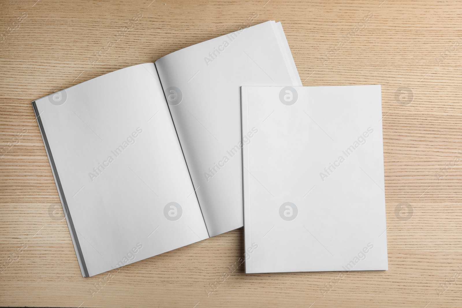 Photo of Open and closed blank brochures on wooden background, top view. Mock up for design