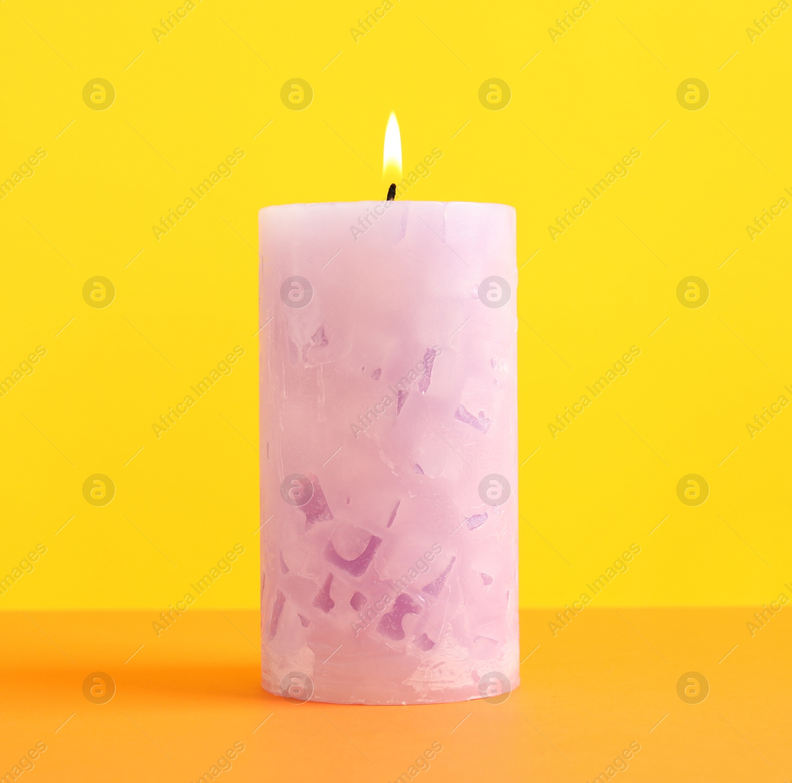 Photo of Alight scented wax candle on color background