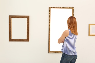 Photo of Woman viewing exposition in modern art gallery