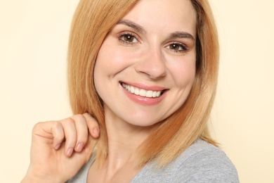 Photo of Portrait of woman with beautiful face on beige background