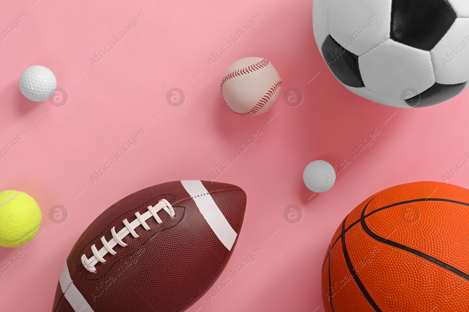 Photo of Many different sports balls on pink background, flat lay