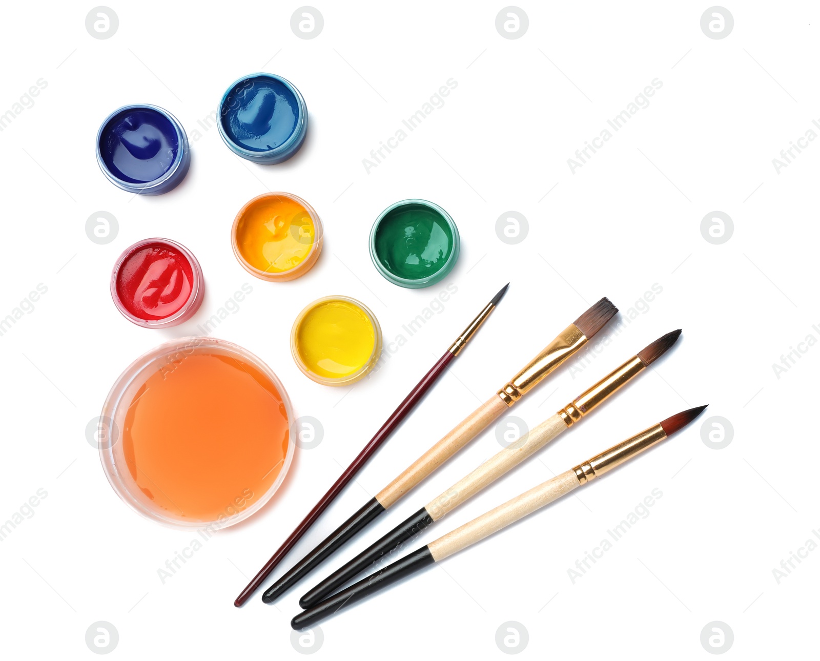 Photo of Composition with different paints, sheet of paper and brushes on light background. Color palette