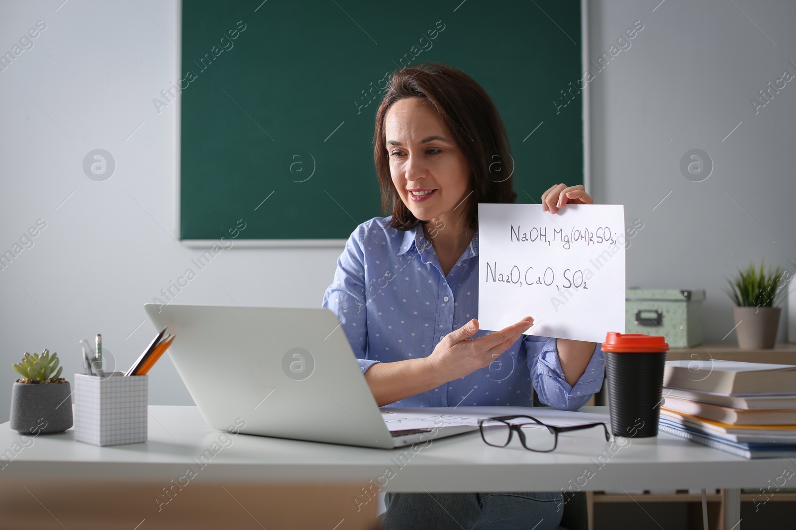 Photo of Teacher conducting online lesson in classroom during COVID-19 quarantine