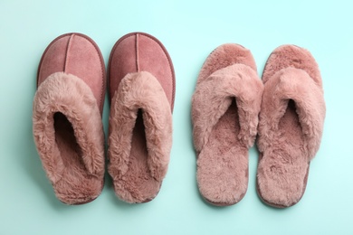 Photo of Different stylish soft slippers on turquoise background, flat lay