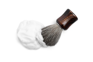 Shaving brush and foam on white background, top view