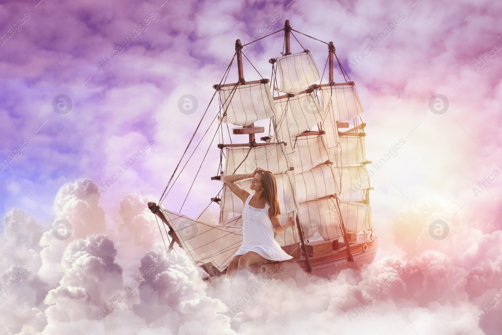 Image of Dream world. Sailing ship with beautiful girl on board floating among wonderful fluffy clouds