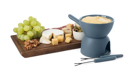 Photo of Fondue with tasty melted cheese, forks and different snacks isolated on white