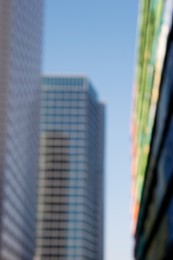 Blurred view of modern buildings on sunny day