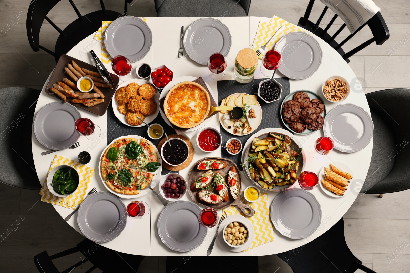 Photo of Brunch table setting with different delicious food and chairs indoors, top view