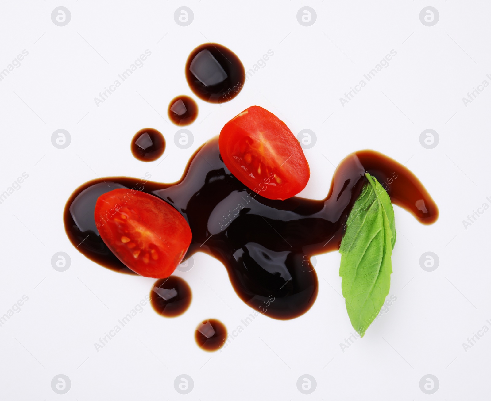 Photo of Tomatoes, basil leaf and balsamic vinegar on white background, flat lay