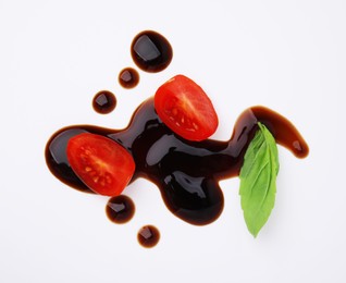 Photo of Tomatoes, basil leaf and balsamic vinegar on white background, flat lay