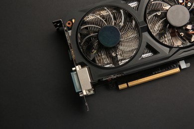 Photo of One graphics card on black background, top view. Space for text