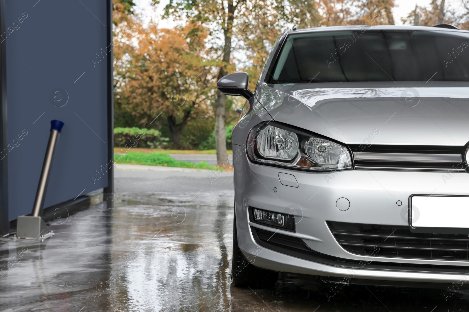 Photo of Silver wet auto at outdoor car wash, space for text