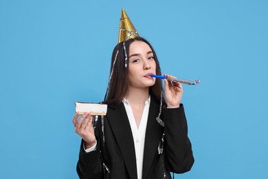 Photo of Woman in party hat with blower and piece of tasty cake on light blue background