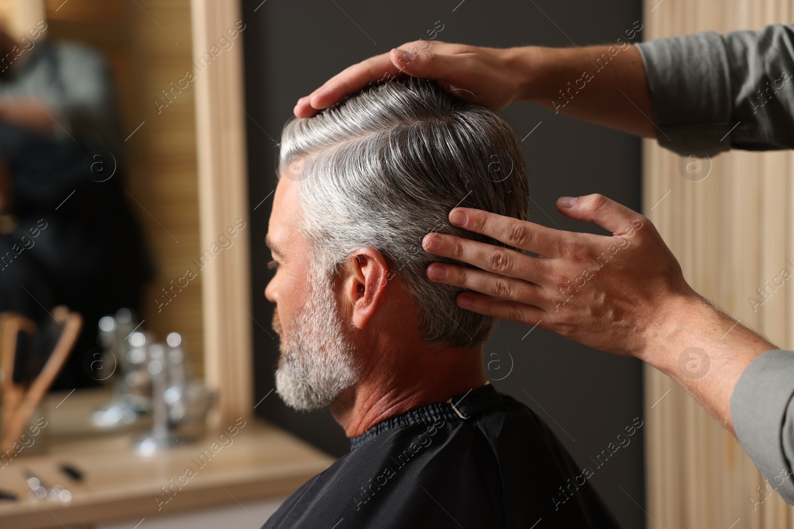 Photo of Hair styling. Professional hairdresser working with client in barbershop, closeup