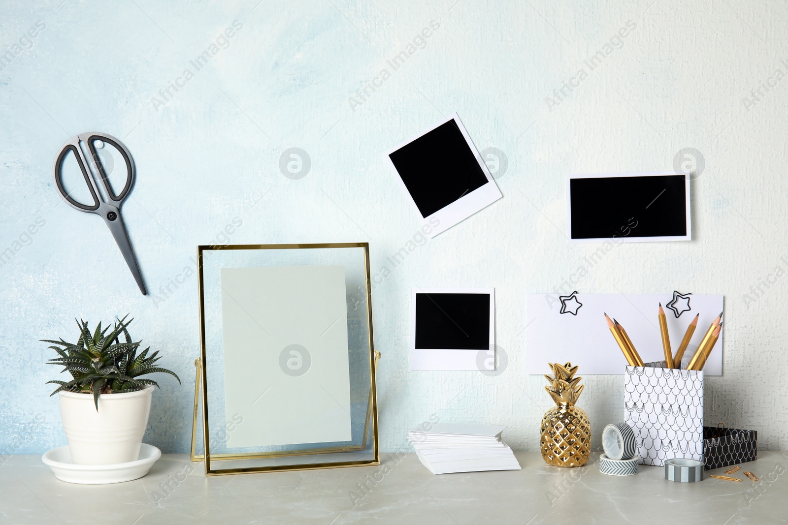 Photo of Set of different decorative elements on table against color wall. DIY blogger