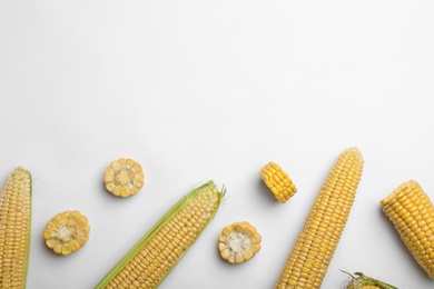 Photo of Flat lay composition with tasty sweet corn cobs on white background