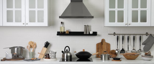 Image of Countertop with different cooking utensils in kitchen, banner design