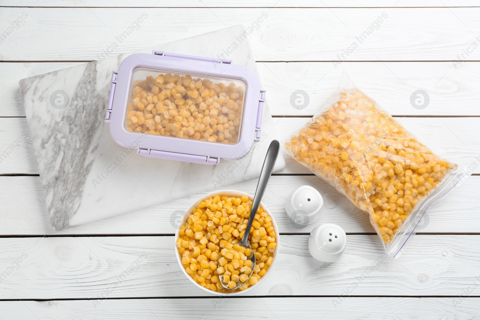 Photo of Flat lay composition with frozen sweet corn on white wooden table. Vegetable preservation