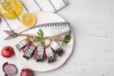 Photo of Tasty salted mackerel, parsley, onion and lemon on white textured table, flat lay. Space for text