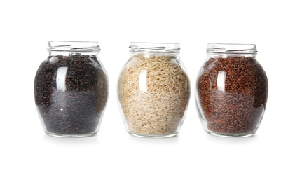 Jars with different types of rice on white background