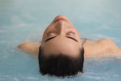 Beautiful woman relaxing in spa swimming pool