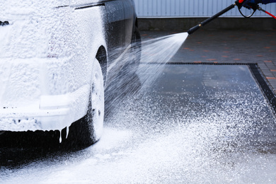 Photo of Covering automobile with foam at car wash